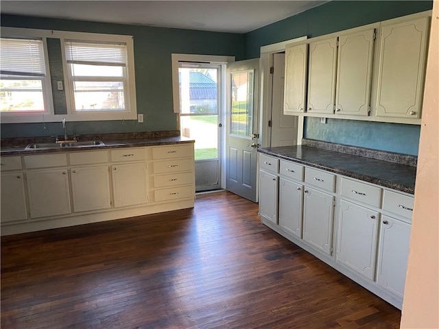 605 W Reynolds St, Newton, IL 62448 - kitchen featuring dark countertops, dark wood finished floors, and white cabinetry