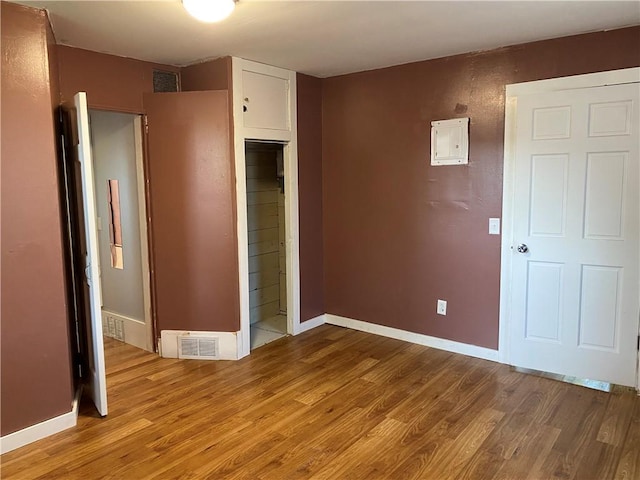 605 W Reynolds St, Newton, IL 62448 - unfurnished room featuring light wood-style flooring and electric panel