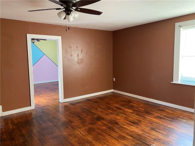 605 W Reynolds St, Newton, IL 62448 - empty room with wood finished floors, ceiling fan, and healthy amount of natural light