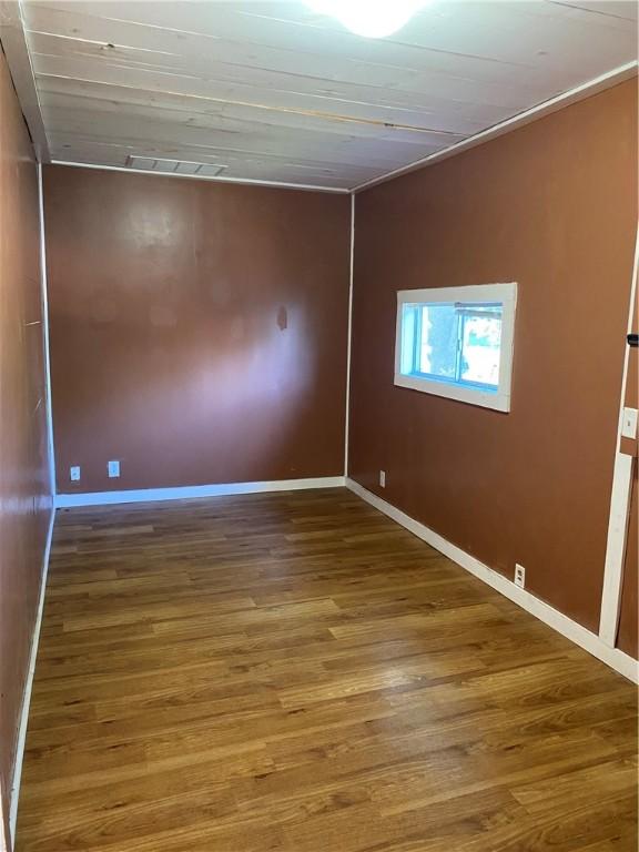 605 W Reynolds St, Newton, IL 62448 - spare room with wood finished floors and baseboards