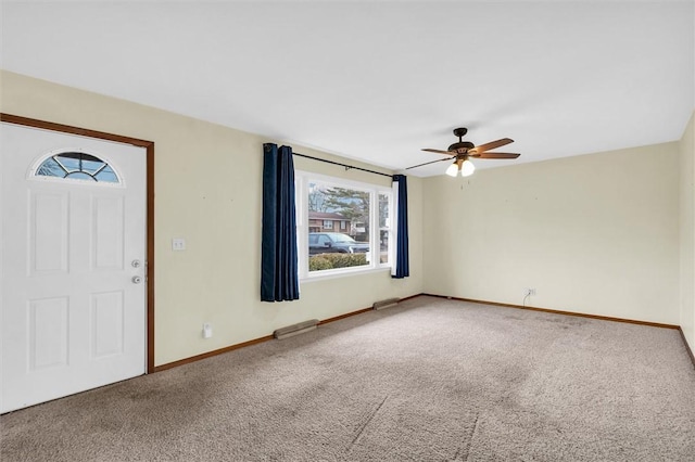 carpeted foyer entrance featuring ceiling fan