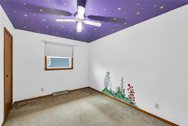 empty room featuring ceiling fan and carpet flooring