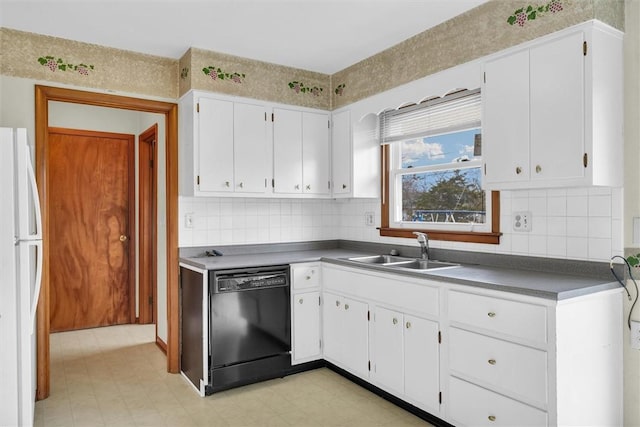 kitchen featuring white cabinetry, white fridge, black dishwasher, and sink