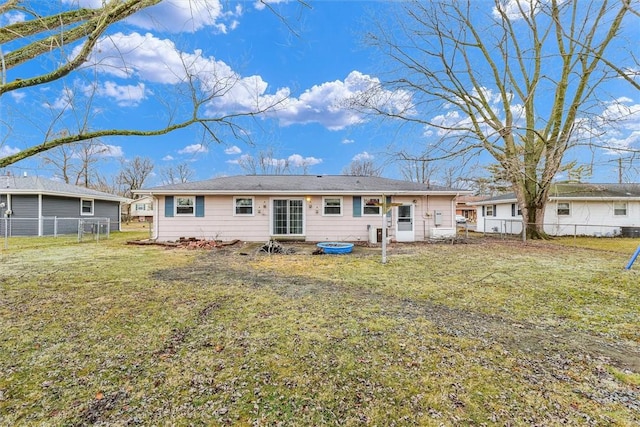 rear view of house with a yard