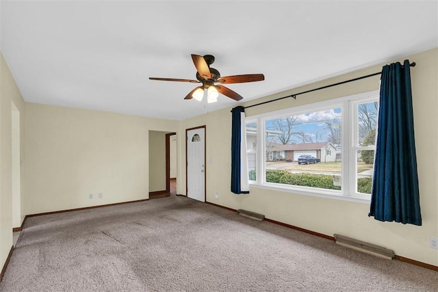 carpeted empty room featuring ceiling fan