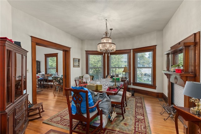 dining area featuring light hardwood / wood-style flooring and a chandelier