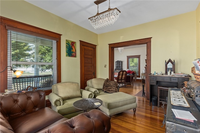 living room featuring hardwood / wood-style floors and an inviting chandelier