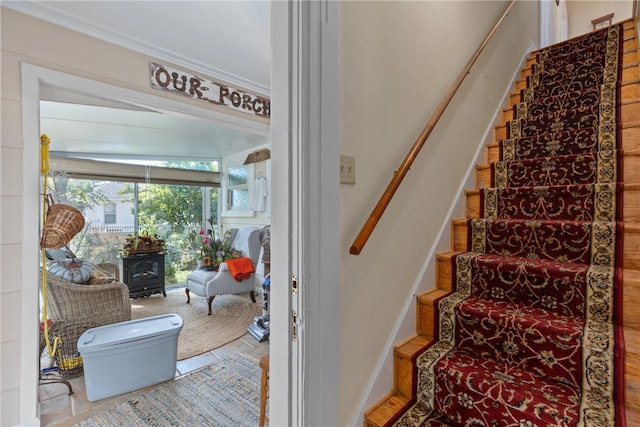 stairway featuring a wood stove