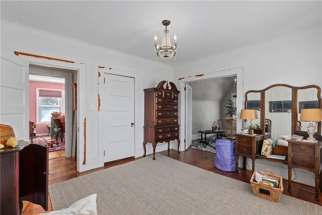 miscellaneous room with crown molding, dark wood-type flooring, and a notable chandelier