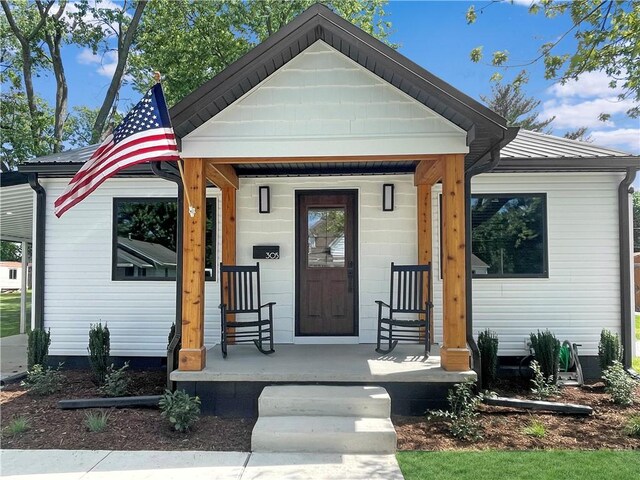 view of front of home featuring covered porch and metal roof