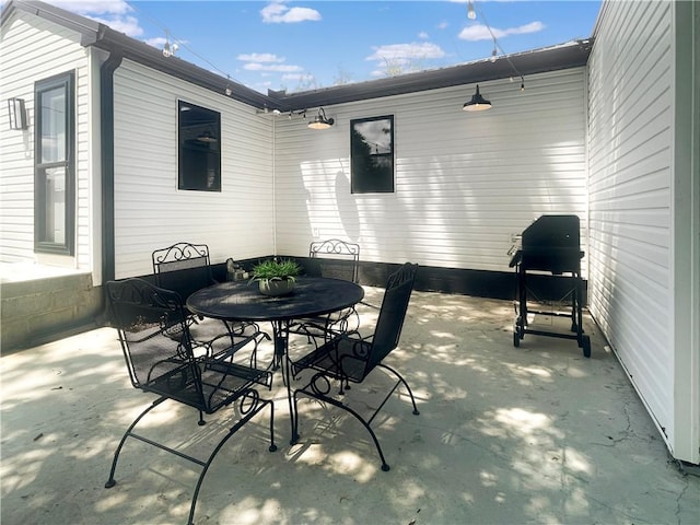 view of patio with outdoor dining area and area for grilling