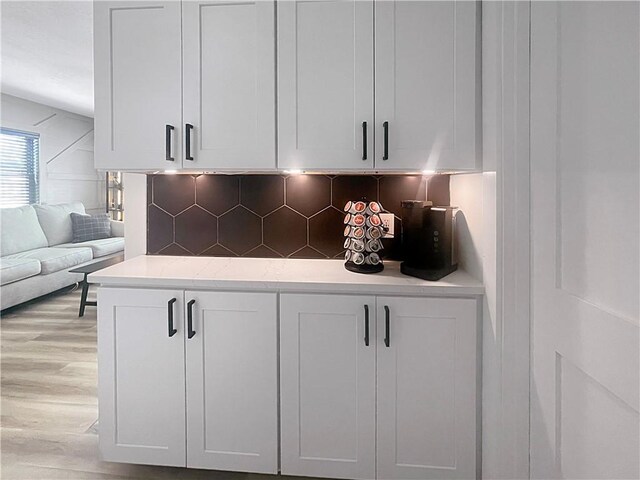 interior space featuring light wood finished floors and decorative backsplash