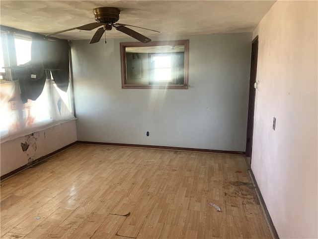 empty room featuring ceiling fan and light hardwood / wood-style flooring