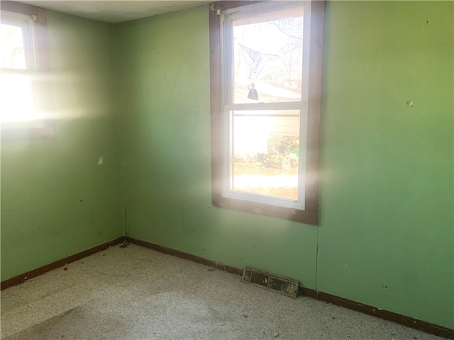 carpeted empty room featuring a healthy amount of sunlight