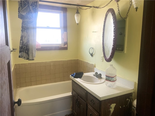 bathroom with vanity and a tub to relax in