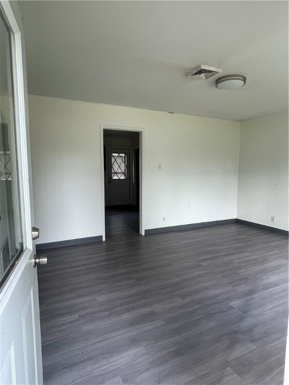 empty room featuring dark hardwood / wood-style flooring