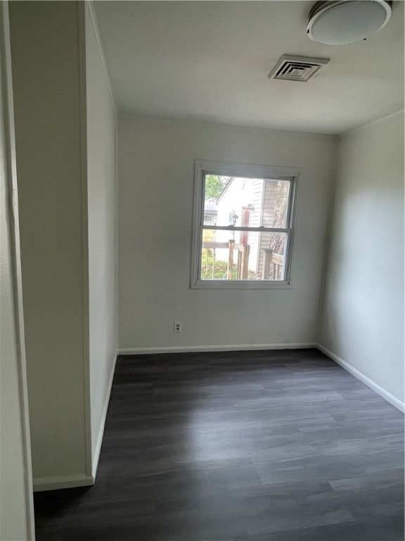 spare room featuring dark hardwood / wood-style flooring