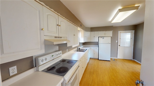 kitchen with white appliances, light hardwood / wood-style flooring, white cabinetry, and sink