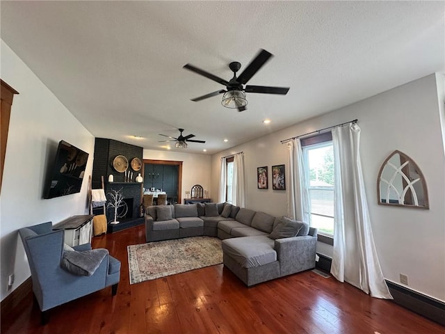 2821 Western Ave, Mattoon, IL 61938 - living area featuring ceiling fan, wood finished floors, a fireplace, recessed lighting, and a textured ceiling