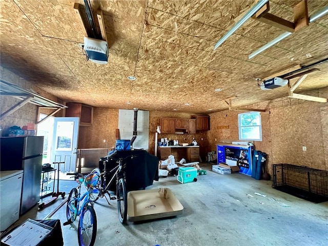 2821 Western Ave, Mattoon, IL 61938 - garage featuring freestanding refrigerator, a garage door opener, and fridge