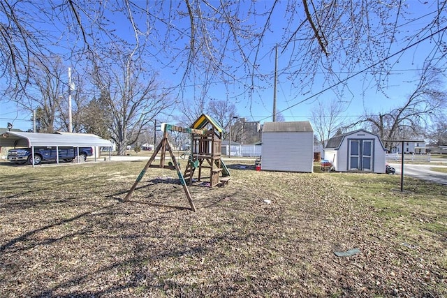 view of yard featuring an outbuilding, a storage shed, a carport, and a playground