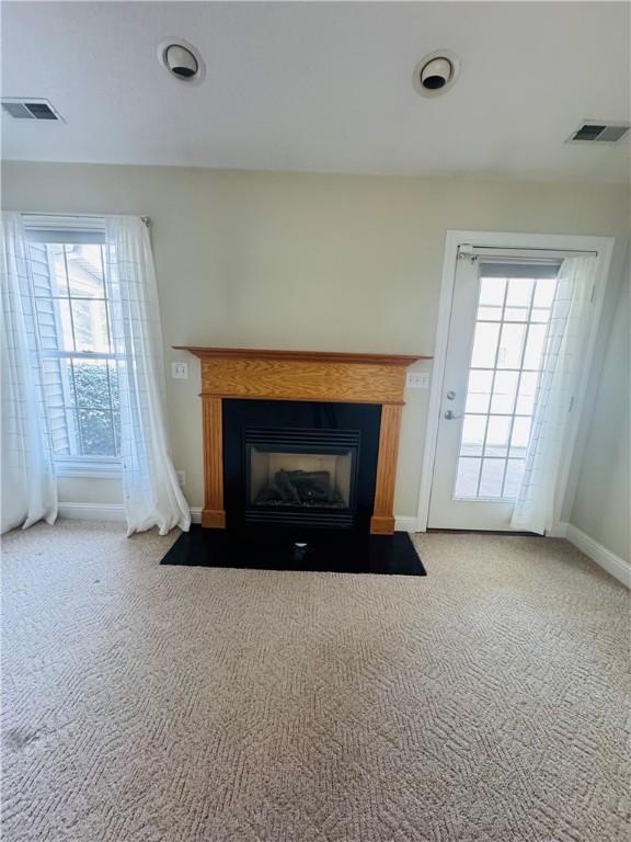 unfurnished living room featuring carpet floors