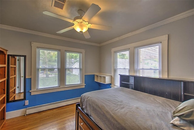 236 N Dennis Ave, Decatur, IL 62522 - bedroom featuring a baseboard heating unit, wood finished floors, multiple windows, crown molding, and ceiling fan