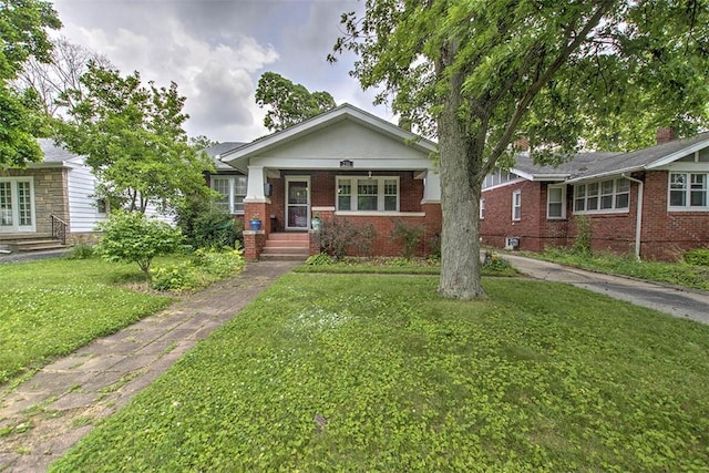 236 N Dennis Ave, Decatur, IL 62522 - view of front of property with a front yard, brick siding, and a porch