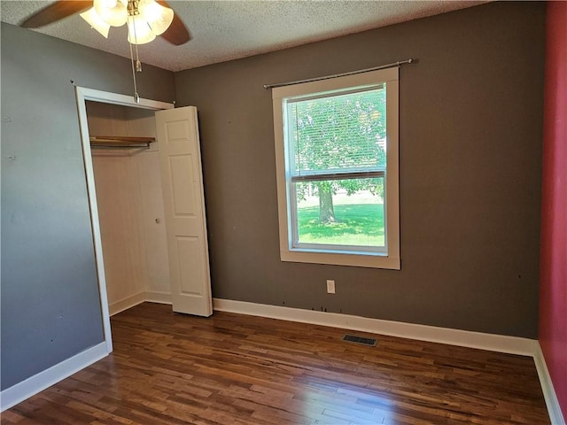 241 S Main St, Argenta, IL 62501 - unfurnished bedroom featuring wood finished floors, a closet, a textured ceiling, and ceiling fan