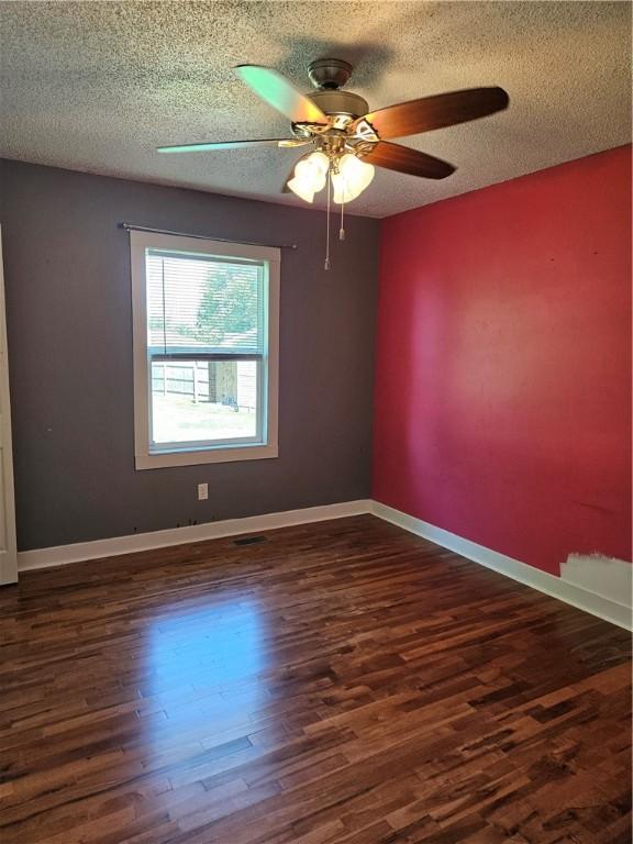 241 S Main St, Argenta, IL 62501 - unfurnished room featuring wood finished floors, a ceiling fan, and a textured ceiling