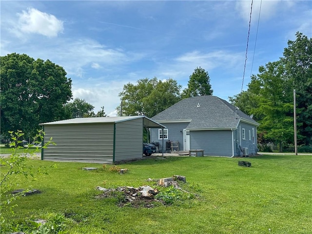 302 E Van Buren St, Paris, IL 61944 - back of property with a yard, an outdoor structure, and roof with shingles