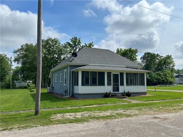 302 E Van Buren St, Paris, IL 61944 - bungalow with a sunroom, a front lawn, and roof with shingles