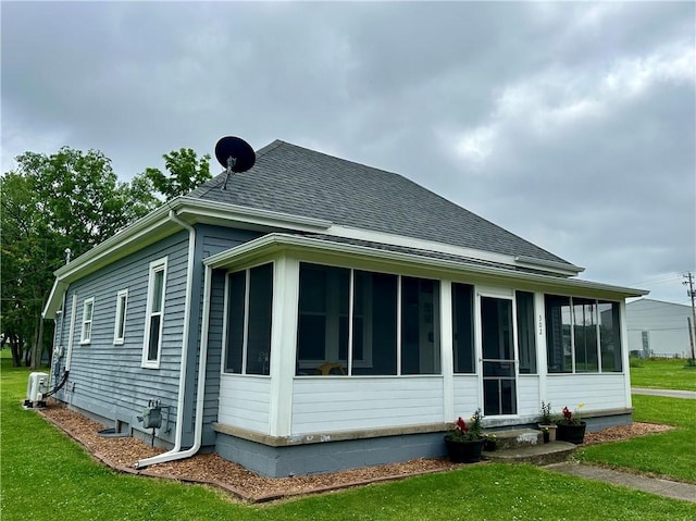 302 E Van Buren St, Paris, IL 61944 - view of side of property with a sunroom, a lawn, and roof with shingles