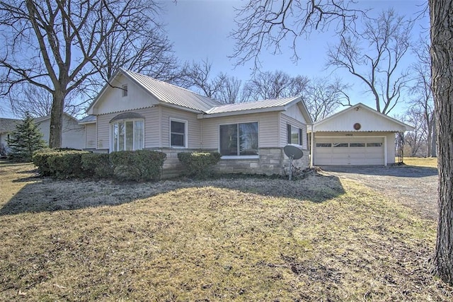 ranch-style home with a garage, stone siding, and metal roof