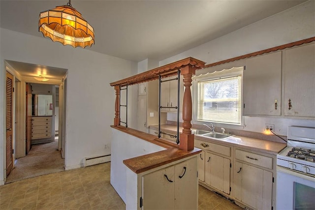 kitchen with light floors, a sink, pendant lighting, white gas range, and baseboard heating