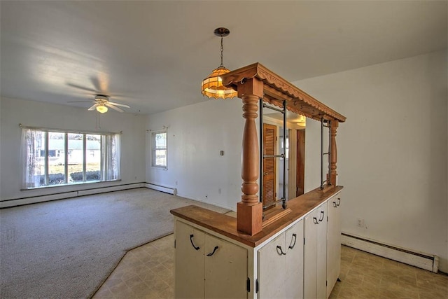 interior space featuring a ceiling fan, baseboard heating, and carpet floors