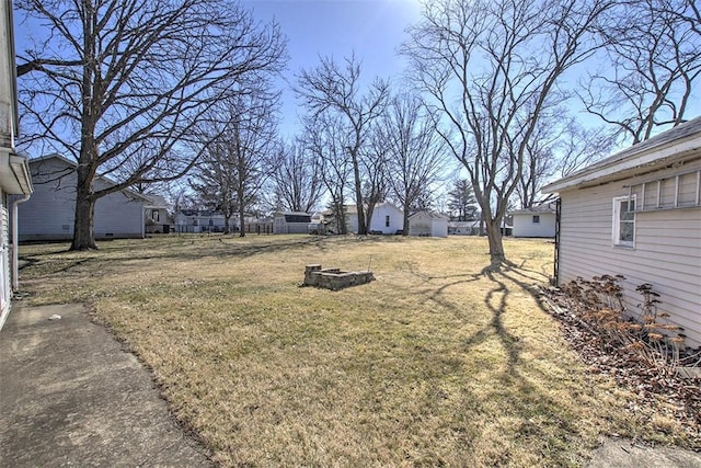 view of yard with a residential view and an outdoor fire pit