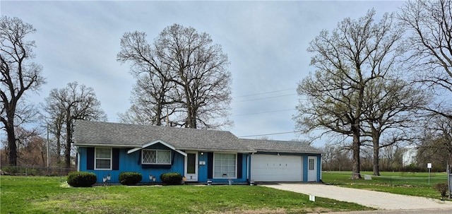 ranch-style home with a garage, driveway, and a front yard