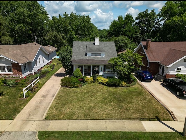 215 E Winter Ave, Danville, IL 61832 - view of front of property featuring concrete driveway, a front lawn, and a chimney