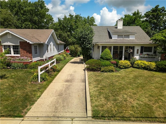 215 E Winter Ave, Danville, IL 61832 - view of front of property with driveway, a chimney, a front lawn, and a shingled roof