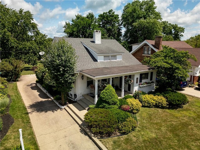 215 E Winter Ave, Danville, IL 61832 - view of front of property featuring a chimney, a porch, roof with shingles, and a front yard