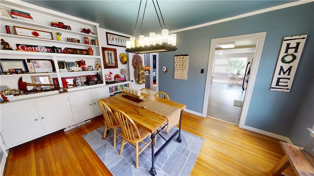 215 E Winter Ave, Danville, IL 61832 - dining room with light wood-style floors and a chandelier