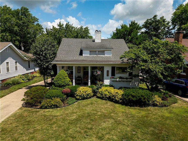 215 E Winter Ave, Danville, IL 61832 - view of front of house featuring a chimney, a front yard, and covered porch