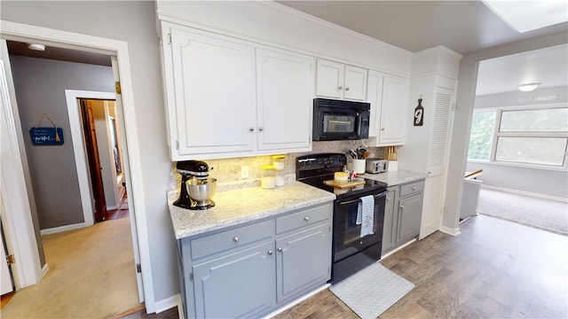 215 E Winter Ave, Danville, IL 61832 - kitchen with black appliances, decorative backsplash, white cabinets, gray cabinetry, and light stone counters
