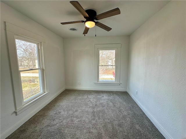 unfurnished room featuring ceiling fan and carpet flooring