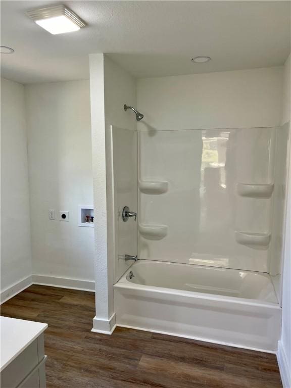 bathroom featuring vanity, hardwood / wood-style flooring, and shower / washtub combination