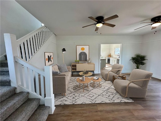 living room featuring dark hardwood / wood-style floors, sink, and ceiling fan