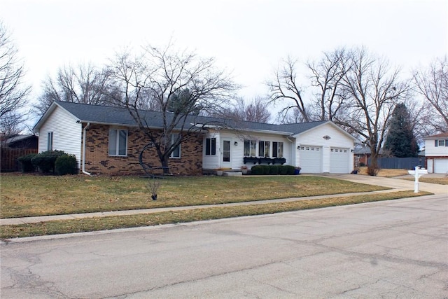 ranch-style house featuring driveway, brick siding, a front lawn, and fence