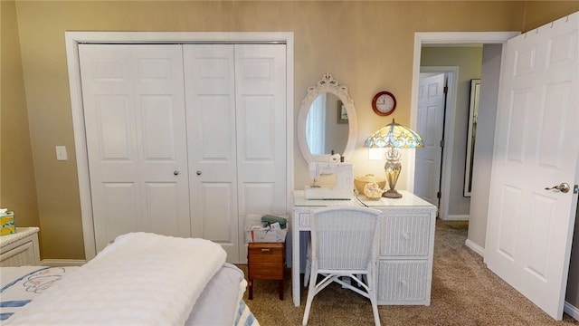 carpeted bedroom with a closet and baseboards