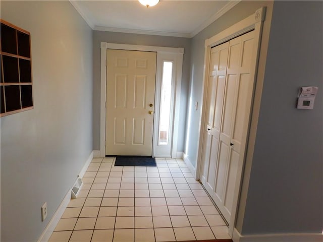 entrance foyer featuring plenty of natural light, baseboards, crown molding, and light tile patterned flooring